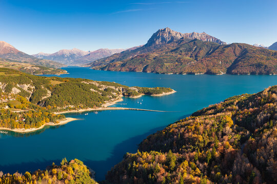 Aerial view of Serre Poncon Lake and Chanteloube Bay with Grand Morgon mountain peak. Hautes-Alpes, French Alps, France