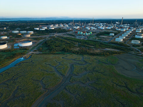 Aerial view of Fawley Refinery with its extensive network of storage tanks and industrial infrastructure situated near the marshlands of Southampton, England, United Kingdom.