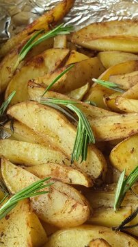 Vertical shot of baked potatoes with rosemary. Food background