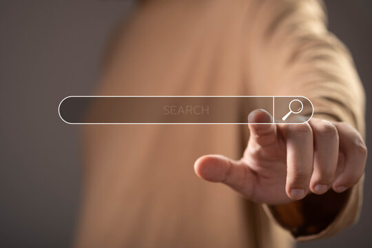 Digital search interface with user selecting an online search bar, representing internet search, information retrieval, SEO strategy, web browsing, online discovery, and digital research technology.