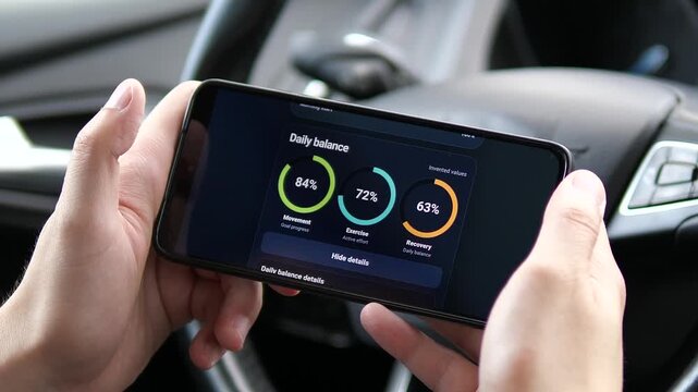 Person reviews movement, exercise and recovery scores on a smartphone, highlighting digital wellness, activity balance and data-driven health tracking.