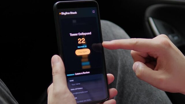 Player reaches a new high score after a virtual tower collapses on a smartphone, highlighting mobile gaming, replay motivation and the psychology of digital rewards.