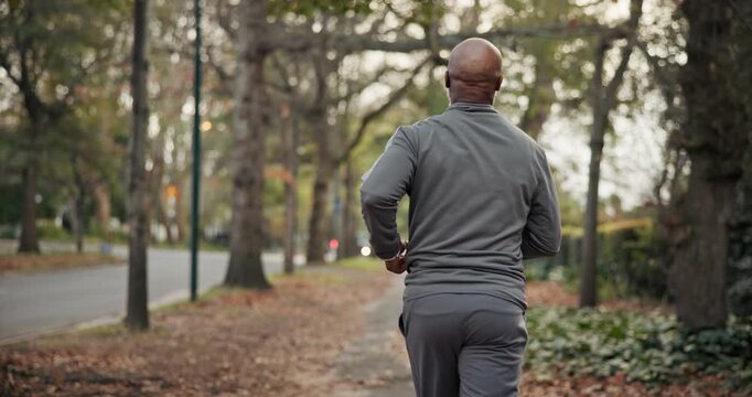 Active, fitness and man on road, running and endurance for physical activity or cardio for wellness. Outdoor, runner and mature person with energy for jog, back and workout routine for health in city
