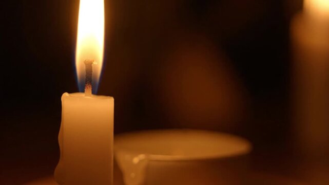 Candle Flame Flickering Softly in the Darkness Providing a Warm and Peaceful Ambiance for Relaxation and Meditation