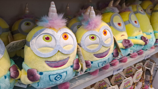 Adorable Minion unicorn costume plush dolls lined up on display shelf in souvenir shop on May 28, 2026 in Bangkok,  Thailand 