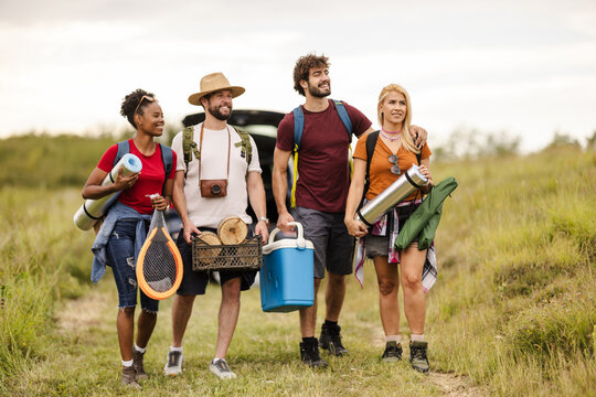 Group of Friends Hiking With Camping Gear on a Trail in the Outdoors