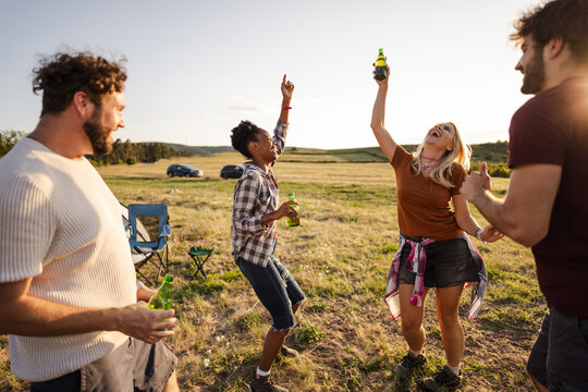Group Enjoys Drinks While Celebrating Outdoors During Sunset