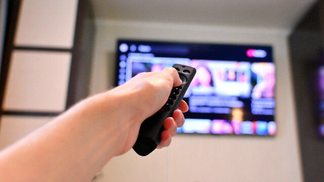 Close hand grip on remote while watching streaming content on tv