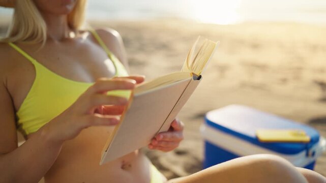 Woman embracing screen-free lifestyle by read book instead of use smartphone while relaxing on beach. Peaceful summer escape, healthy habits, mindfulness, outdoor leisure and modern wellness concept