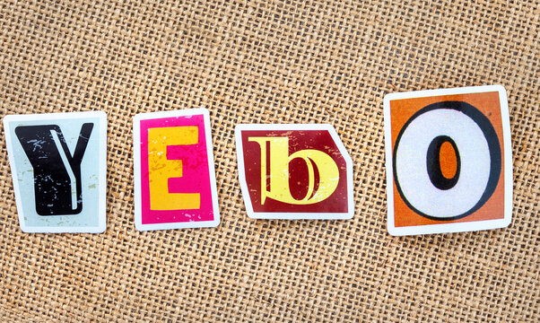 Yebo South African slang word spelled with colorful magazine style alphabet stickers on rustic burlap background