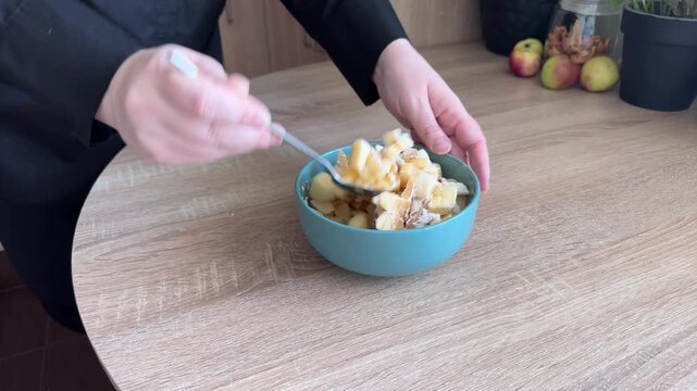 Mixing fresh apple filling with cornstarch for homemade pastry preparation