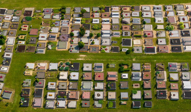 Aerial view of the cemetery featuring numerous rectangular grave plots arranged in neat rows on a grassy field Juzintai, Panevezys County, Lithuania.