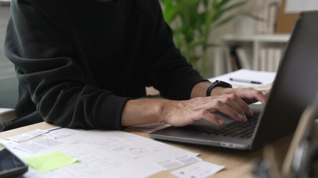 A male designer working on website prototype, in UX UI concept design  and development for a website and mobile app prototype