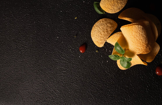 Top view of a stack of chips on black background with space for an inscription