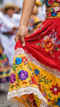 Colorful embroidered skirt in colombian flower festival parade, silletero tradition, floral textile craft, folkloric dance costume, lace detail, vibrant yellow fabric, cultural celebration