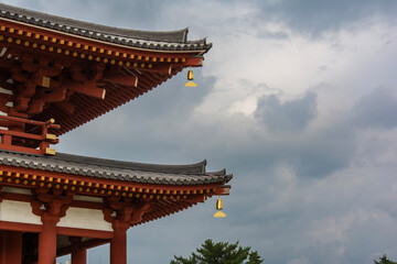 Fototapeta premium Traditional Japanese Temple Roof Eaves Against Cloudy Sky