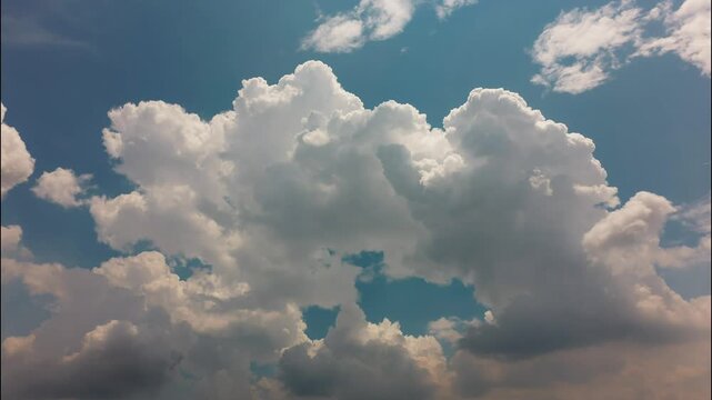 White puffy clouds drifting across a bright blue sky during a sunny afternoon capturing nature in motion