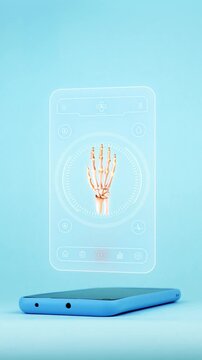 Doctor using a mobile app on his smartphone to diagnose hand bones. Innovative technology for the early detection of arthritis and wrist fractures. Light blue background.