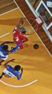 Overhead View of Basketball Players Contesting a Shot Near the Rim