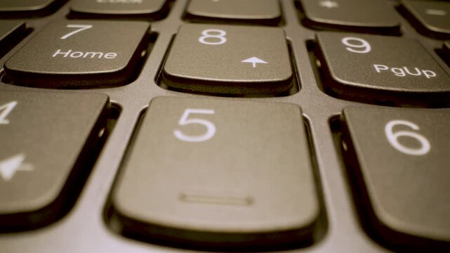 modern laptop keyboard keys, close up gliding view with shallow depth of field