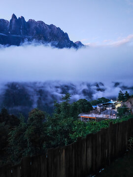 Misty mountain peaks above clouds with forest landscape in China