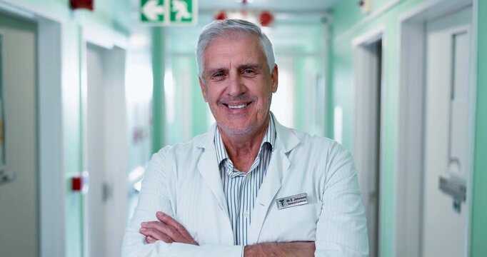 Happy, face and doctor in hospital hallway for medical career, wellness and health support. Crossed arms, healthcare and portrait of mature man with confidence, pride and smile for friendly service