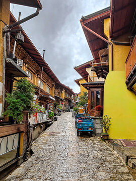 Traditional Chinese village street with colorful buildings and stone pathway