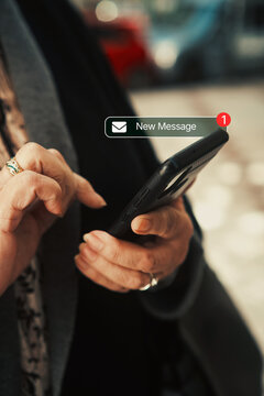 Mature woman receiving new message notification on smartphone. Texting, mobile technology use among older adults, and staying connected through smartphones concepts.