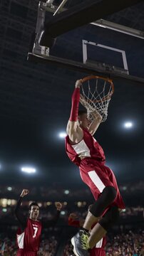 Basketball Player Dunking the Ball in a Packed Arena with Cheering Crowd