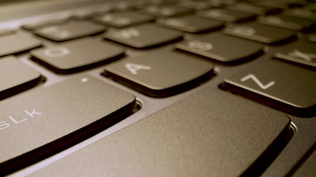 modern laptop keyboard keys, extreme close up gliding shot