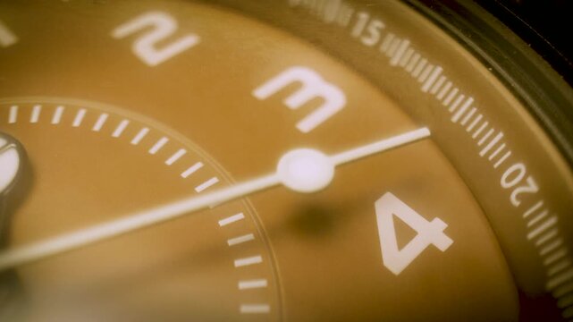 close up of wristwatch dial with ticking second hand
