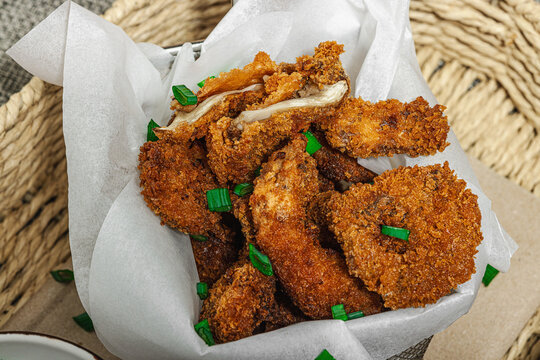 Battered and deep-fried oyster mushrooms (Pleurotus) with dipping sauce and green onion