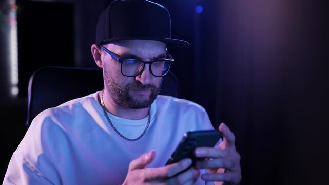 Music Producer Checking Smartphone In Professional Recording Studio