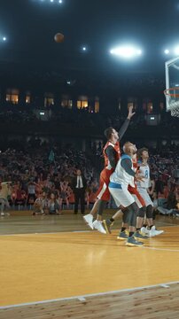 Basketball Players Celebrating with Raised Fists in a Packed Arena