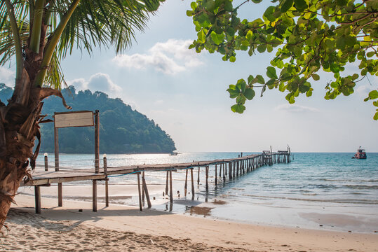 Scenic view of a long wooden bridge on a tropical island during summer vacation, authentic photo, not AI.