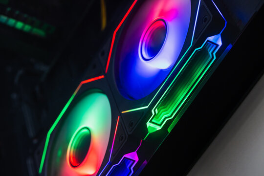 Vibrant RGB fans illuminate a custom gaming PC interior, showcasing multicolor LED lighting, airflow-focused cooling components and modern hardware details for high-performance desktop builds