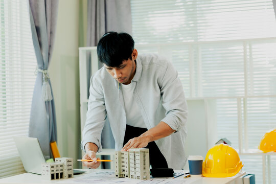 Confident mathematical engineer verifying building safety load tolerances using advanced business logic desktop.