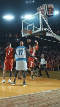 Basketball Players High-Fiving After a Play in a Packed Arena