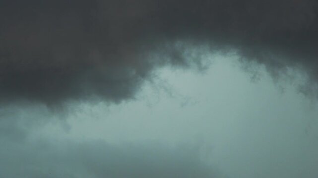 Dramatic Dark Storm Clouds Moving Fast with Flock of Birds Flying Before Heavy Rain