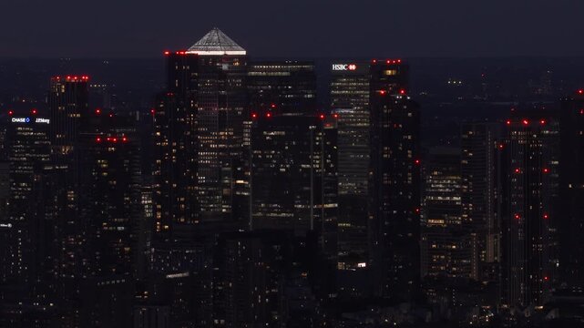 Canary Wharf Financial District and Illuminated Office Towers at Night in London, UK