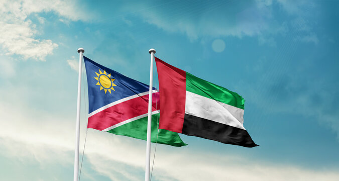 Namibia and UAE friendship flags are waving in the sky. Double country Flag waving with mast. Namibia UAE national flag for agreement.