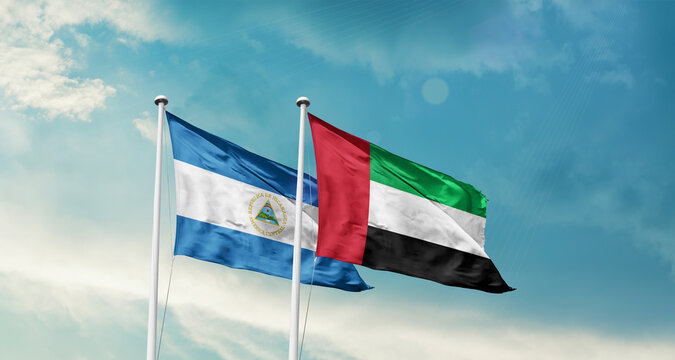 Nicaragua and UAE friendship flags are waving in the sky. Double country Flag waving with mast. Nicaragua UAE national flag for agreement.