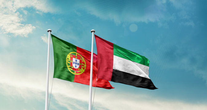 Portugal and UAE friendship flags are waving in the sky. Double country Flag waving with mast. Portugal UAE national flag for agreement.