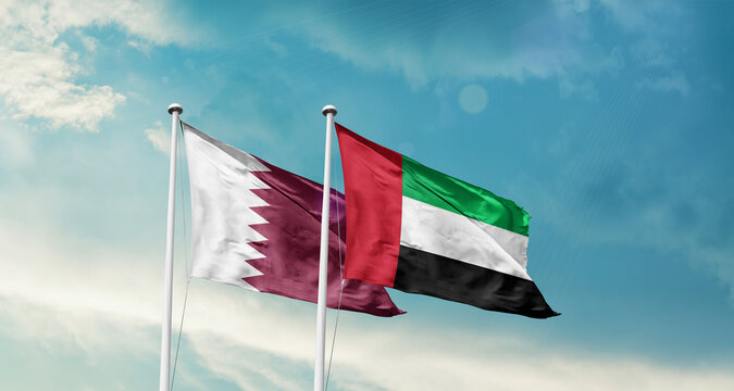 Qatar and UAE friendship flags are waving in the sky. Double country Flag waving with mast. Qatar UAE national flag for agreement.