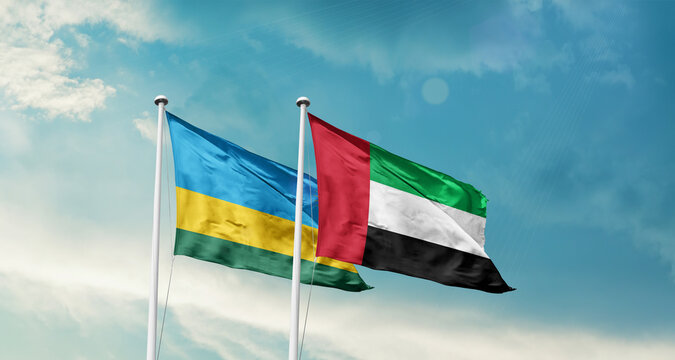 Rwanda and UAE friendship flags are waving in the sky. Double country Flag waving with mast. Rwanda UAE national flag for agreement.