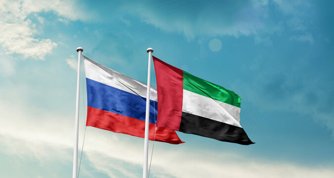 UAE and UAE friendship flags are waving in the sky. Double country Flag waving with mast. UAE UAE national flag for agreement.