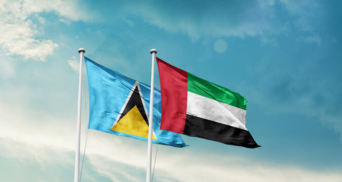 Saint Lucia and UAE friendship flags are waving in the sky. Double country Flag waving with mast. Saint Lucia UAE national flag for agreement.