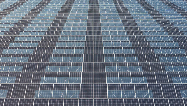 Aerial view of photovoltaic greenhouse roofs with alternating glass and solar panel sections in Saulce-sur-Rhone, Auvergne-Rhone-Alpes, France.