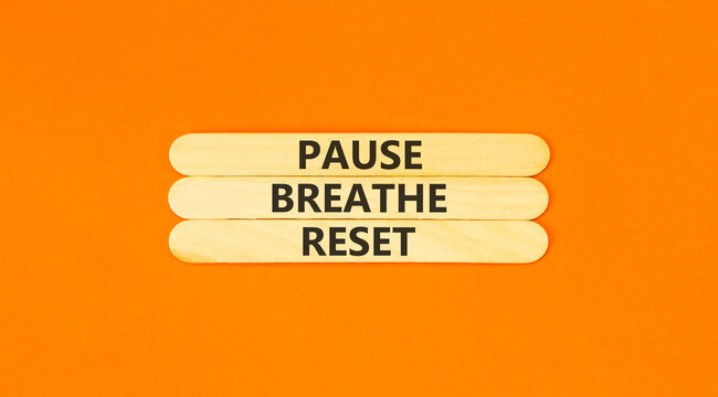 Pause breathe reset words symbol. Concept words Pause breathe reset on beautiful wooden sticks. Beautiful orange background. Business support motivational and pause breathe reset concept. Copy space.
