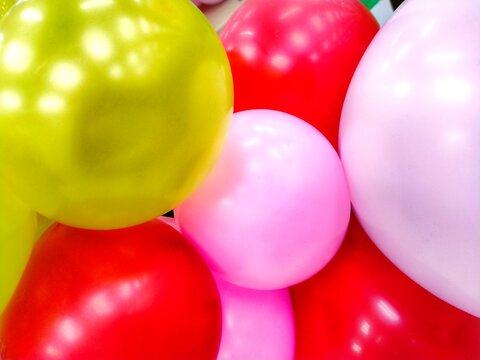 Colorful Party Balloons Background with Bright Pink Red and Yellow Balloons